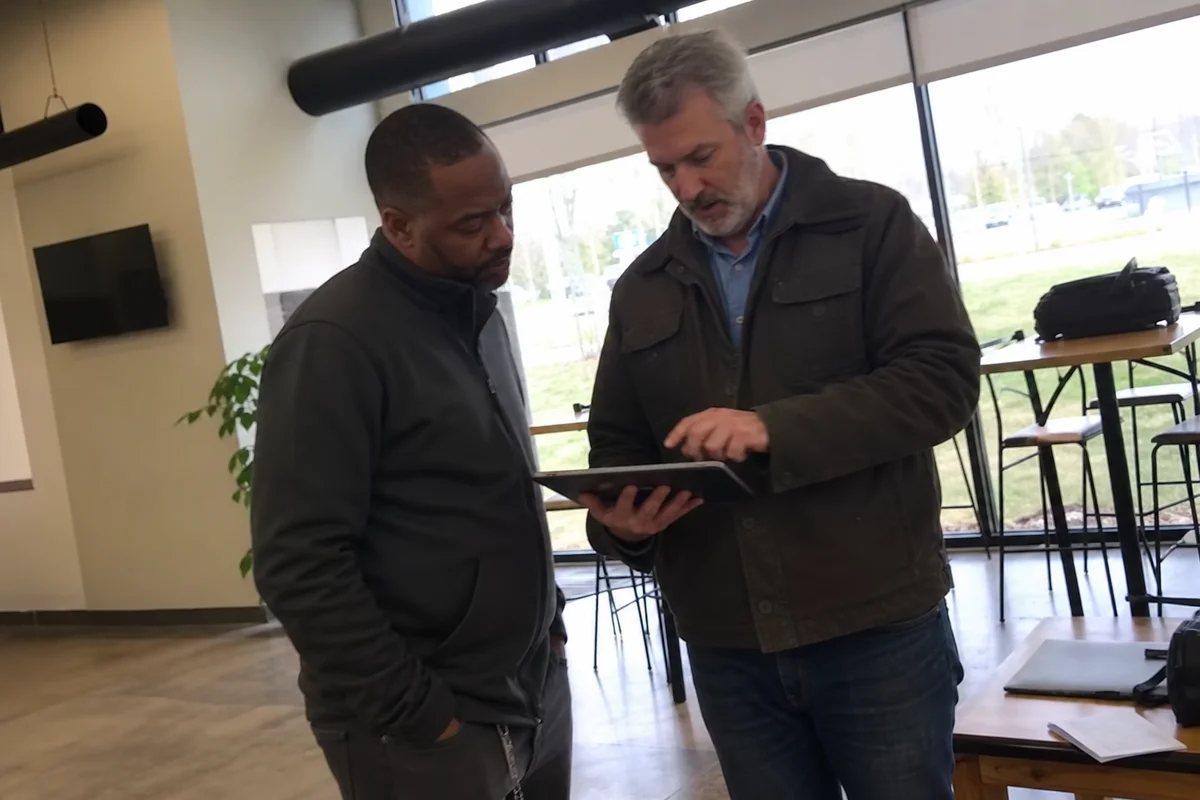 Manager and restoration lead reviewing phased timeline
