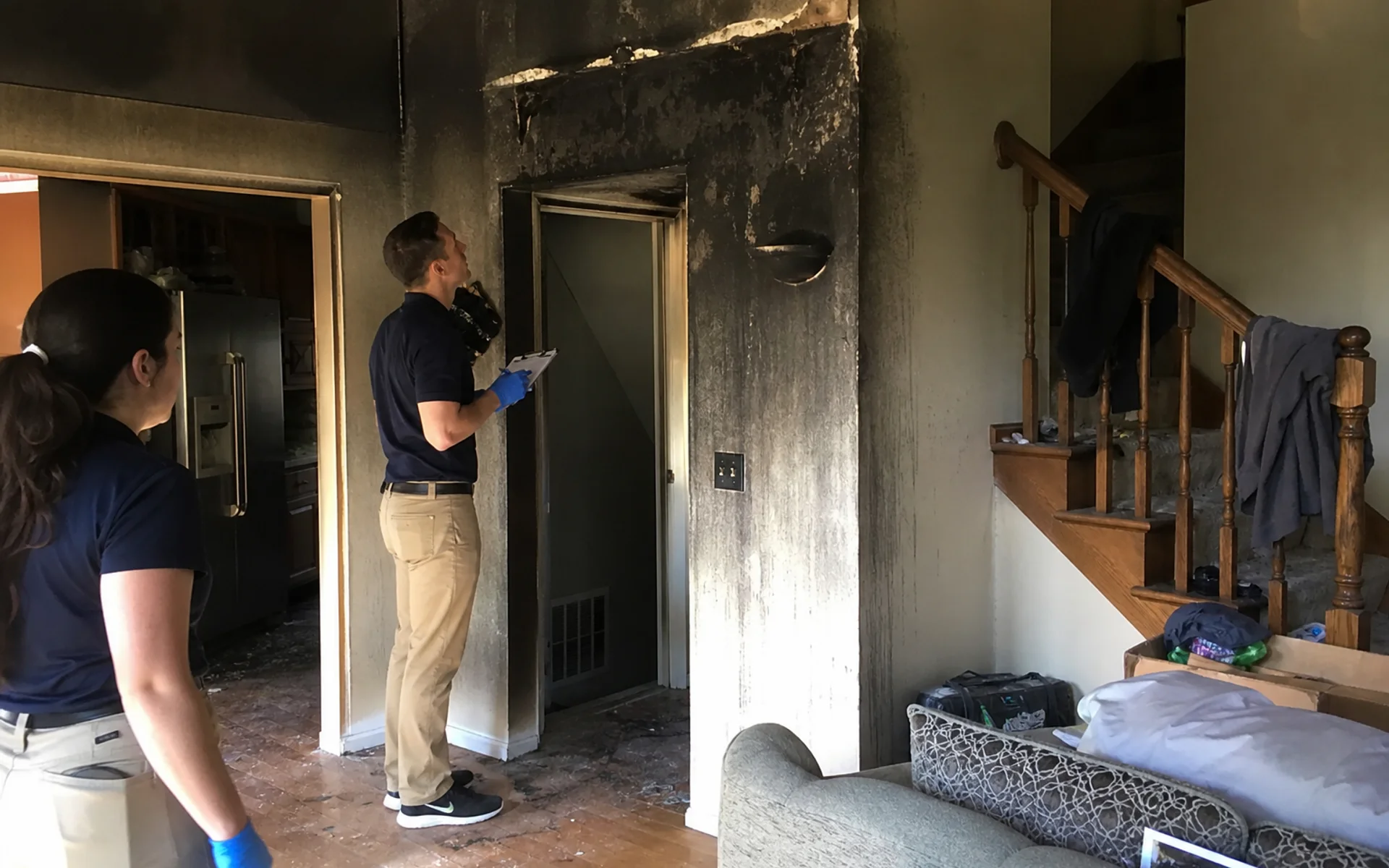 Fire damaged home interior being assessed by restoration crew