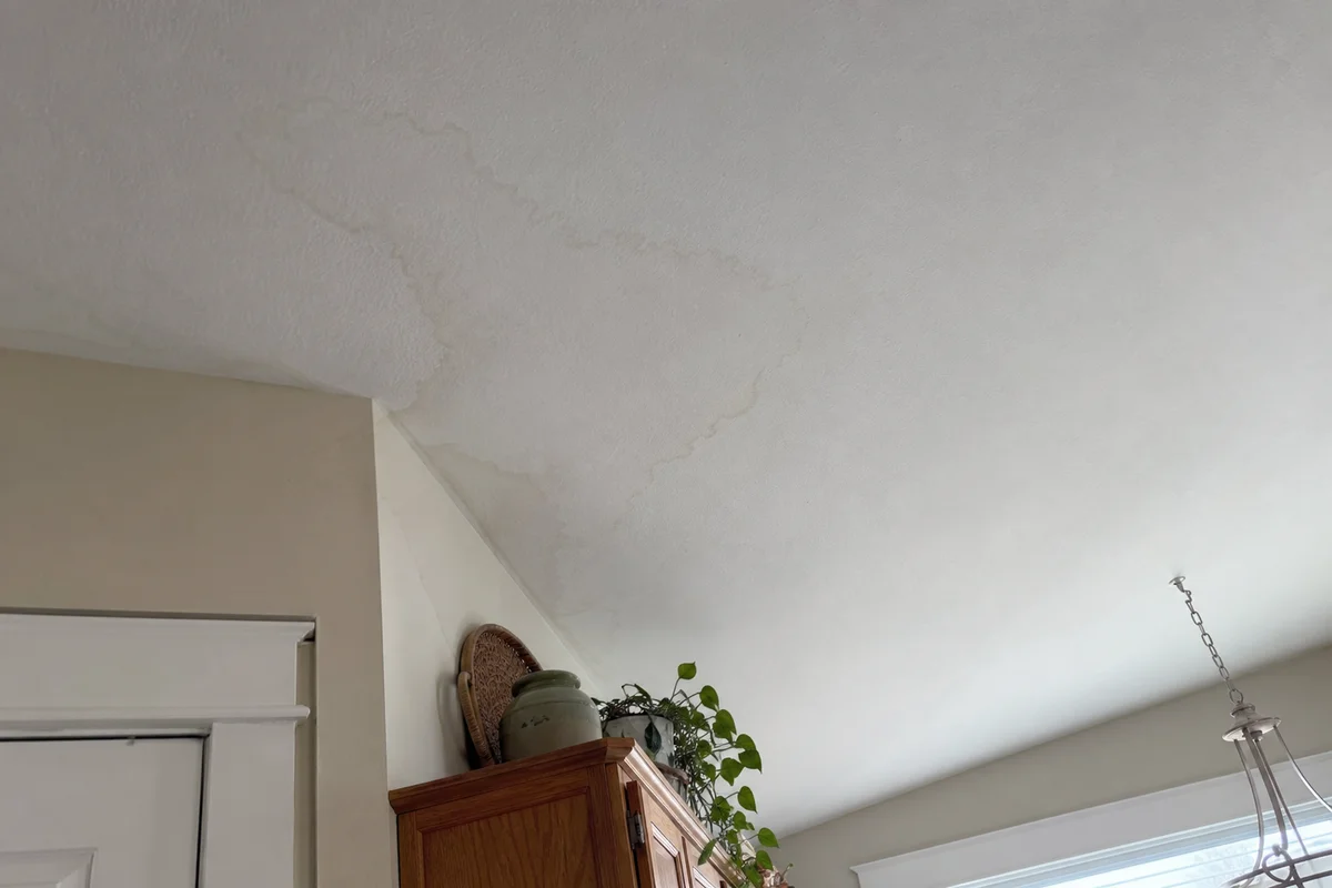 Water stain spreading across a ceiling corner